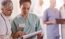 Two medical professionals review paperwork together